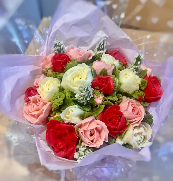 Elegant white wedding cake decorated with fresh flowers